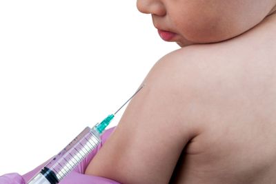 Doctor injecting a young child with vaccine