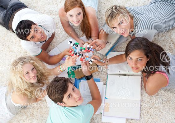 High angle of teenagers studying Science on the floor