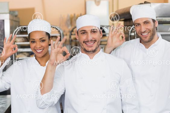 Team of bakers smiling at camera