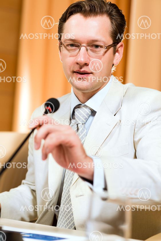 Portrait of a business man with microphone