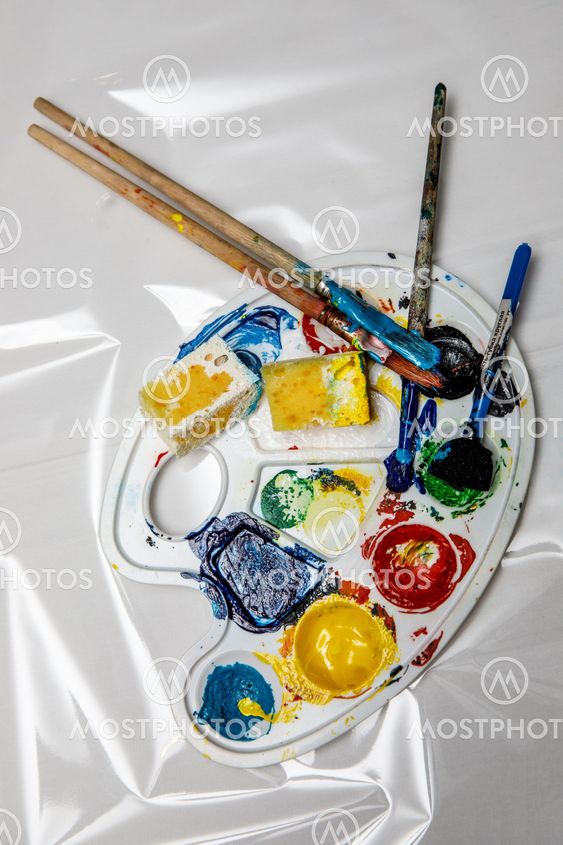 Art palette with tubes of watercolor paints and a brushes