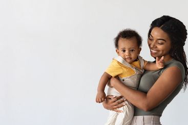 Motherhood Concept. Smiling Young Black Mother Holding...