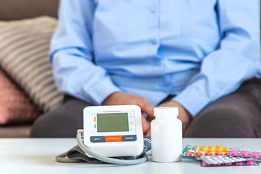 An old woman measures her blood pressure. Selective focus.