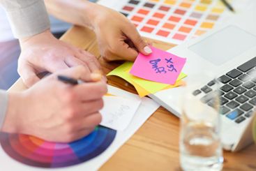 Hands, laptop and team with color palette at office,...