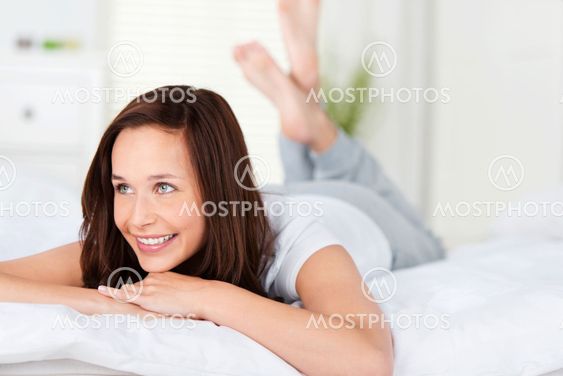 Beautiful woman relaxing on her bed