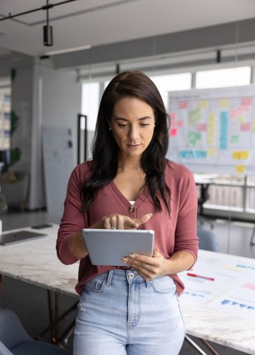 Serious business project leader woman typing on digital...