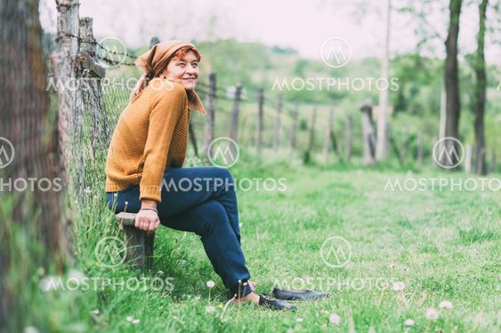 Peasant mature woman sitting on the bench