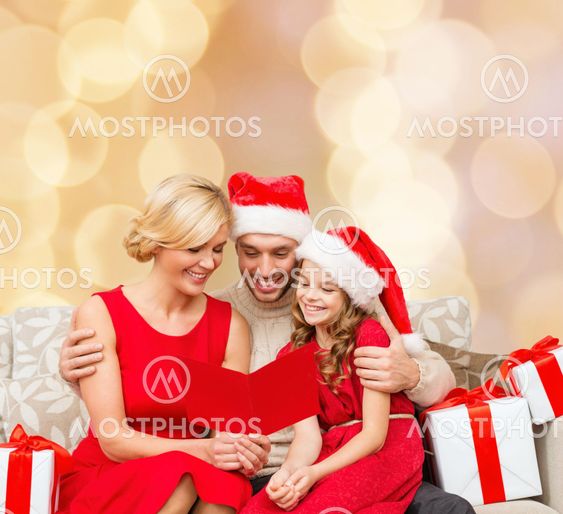 happy family in santa helper hats with gift boxes