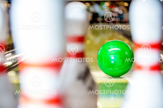 Bowling ball approaching pins