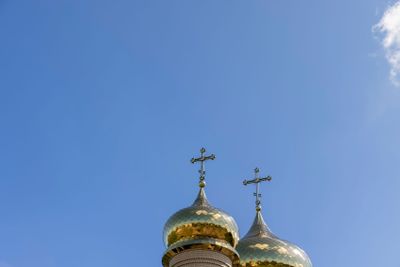 wooden christian cross on a blue sky background
