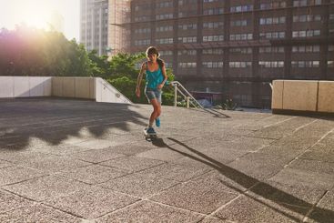 Skateboard, sports and girl in city for skating stunt,...