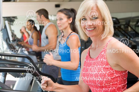 Woman Running On Treadmill At Gym