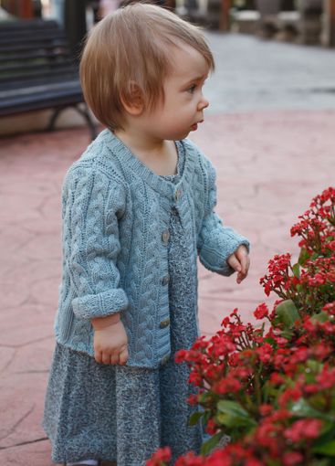 Beautiful baby girl 1 year old playing in the yard outdoors