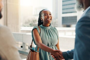 Meeting, smile and handshake with business woman in city...