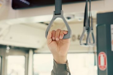 Hand, bus and safety with person, handle and travel with...