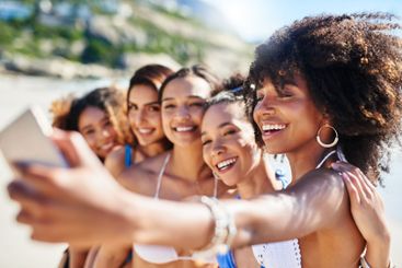 Friends, smile and women with selfie by beach for summer...