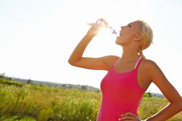 Woman, fitness or drinking water with nature for break,...