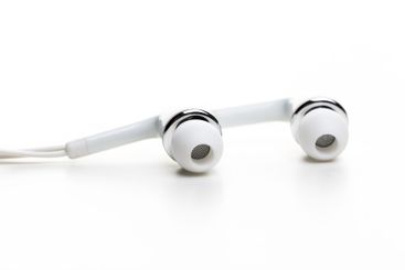 Pair of earphones close up on grey background