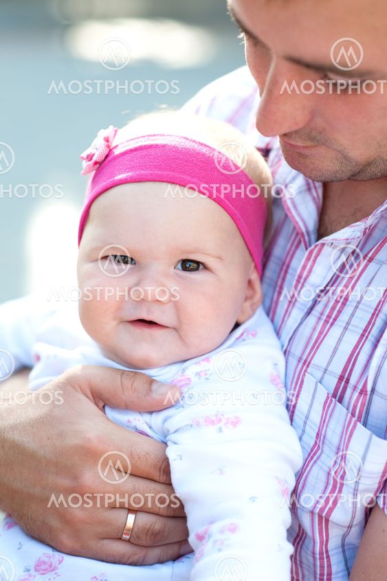the baby on arms of the loving father