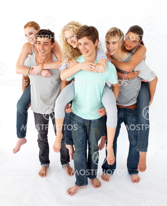 Teenagers giving their friends piggyback rides