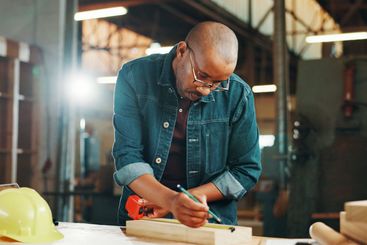 Measuring tape, wood and writing with carpenter black...