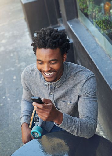 Skateboard, black man and happy with phone outdoor for...
