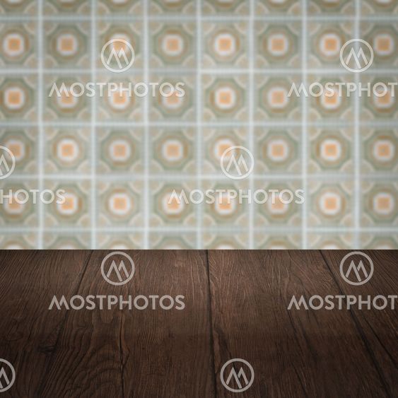 Wood table top and blur vintage ceramic tile pattern wall
