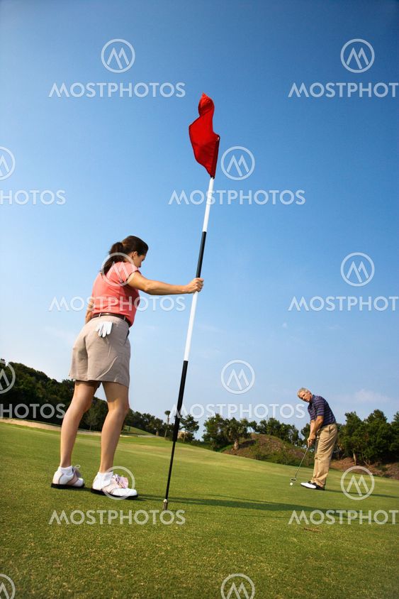 Couple playing golf.
