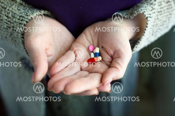 Drugs in old woman's hands. Close up photo. Lifestyle...