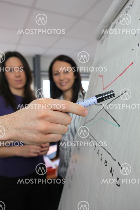 Man presenting statistics on paperboard