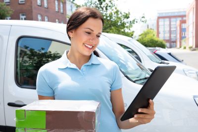 Delivery Woman Holding Cardboard Box And Tablet