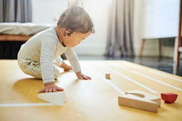 Boy kid, blocks and playing on floor in home, childhood...