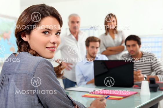 Students gathered around laptop in class