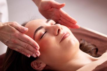 Female Physiotherapist Providing Reiki Therapy