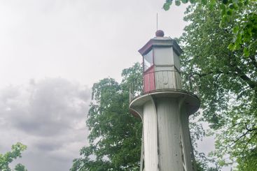 lantern room of an old lighthouse on the seashore among...