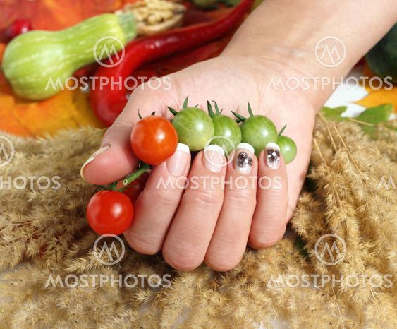 cherry tomatoes and a woman hand