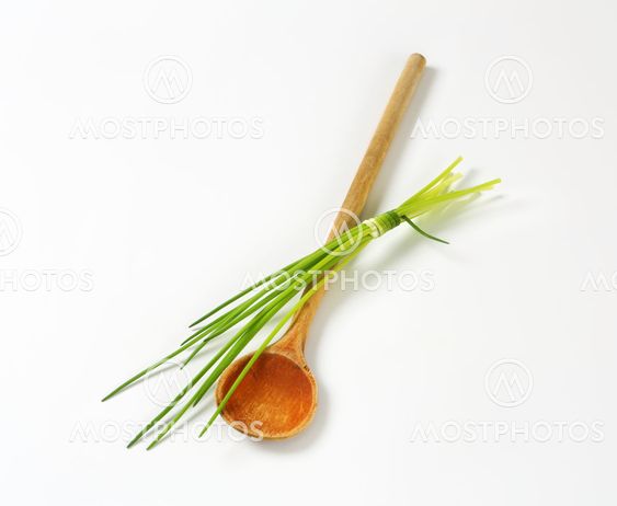 Chives and a wooden spoon