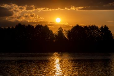 the lake with orange water in the summer at sunset