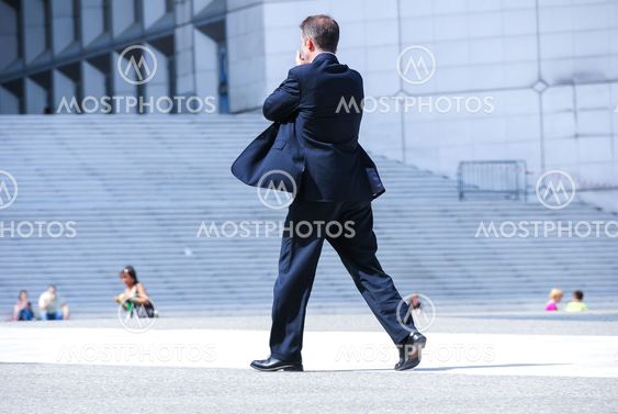 business man holding brief case and walking
