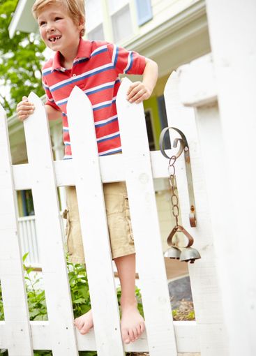 Happy boy, fence and waiting with joy for holiday,...