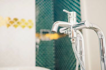 Close-up of clean polished chrome plated faucet and...