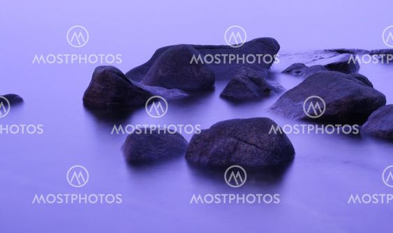 Rocks on a mirror blank pruple winter sea