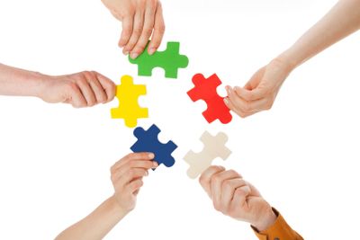 Friends Holding Colorful Jigsaw Pieces