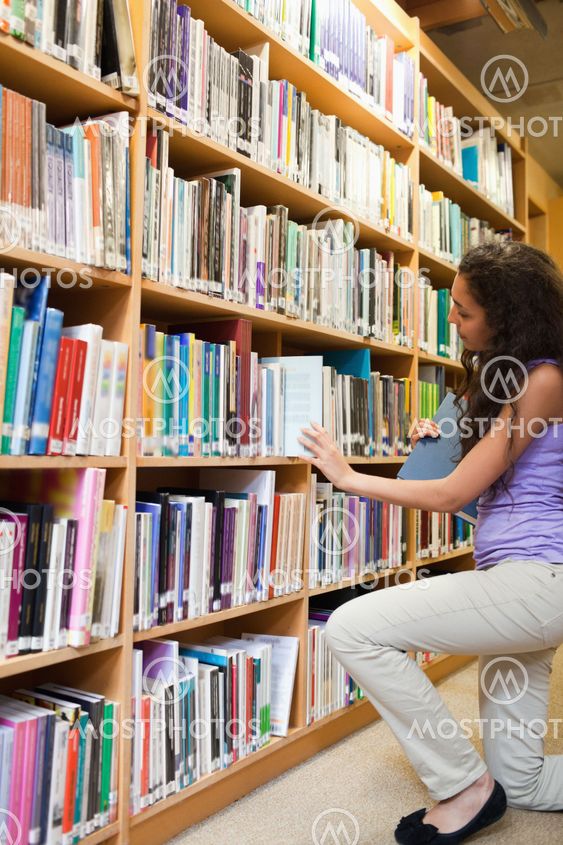 Portrait of a female student choosing a book