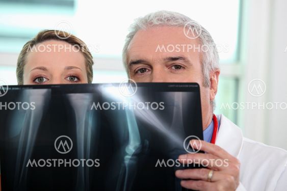 Doctor and nurse looking at x-ray