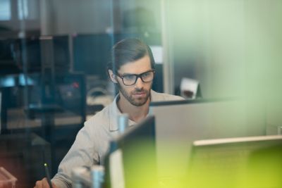Concentrated businessman working on computer at office