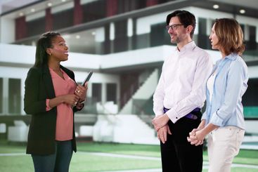 Professional Real Estate Agent Shakes Hands in Front