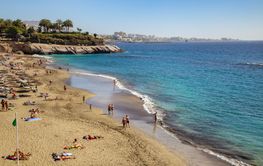 The beach with people in popular resort Costa Adeje in...