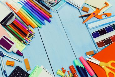 Brightly colored stationery supplies arranged on a...