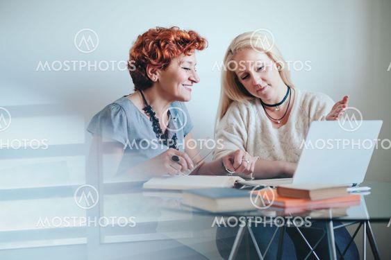 Two businesswoman exchanging ideas